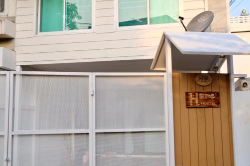 a house with a gate and a sign on it at Home Story Hostel Chiang Mai in Chiang Mai