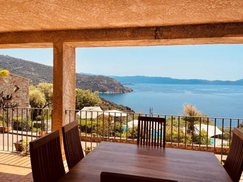 a dining room table with a view of the water at Residence Roc E Mare Cargèse in Cargèse