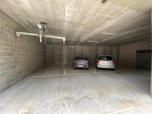 a garage with two cars parked in it at Appartamento Randa in Malcesine