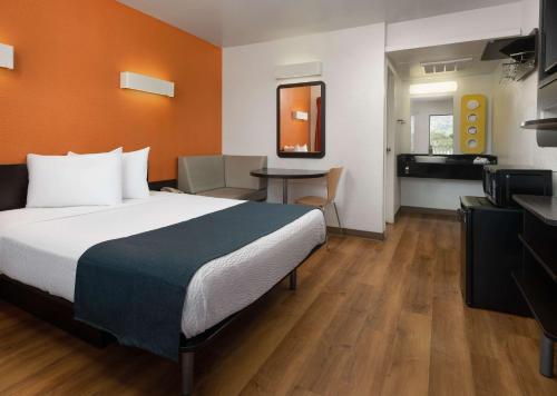 a hotel room with a bed and a table at Motel 6-Carpinteria, CA - Santa Barbara - North in Carpinteria