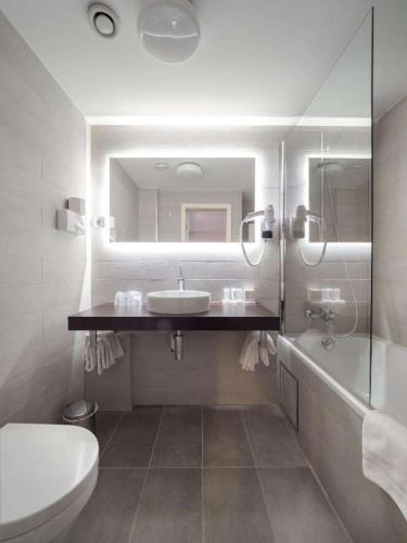 a bathroom with a sink and a toilet and a mirror at Hotel Best Western City Centre in Brussels