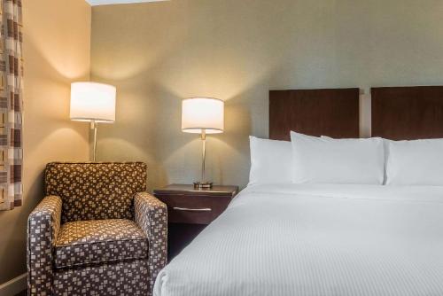 a hotel room with two beds and two lamps at Clarion Inn Belle Vernon in Belle Vernon