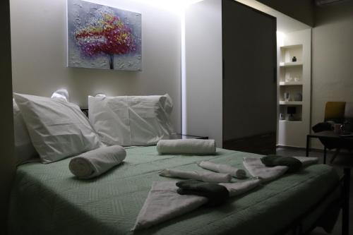 a bed with towels on top of it at COSY APARTMENTS in Chania