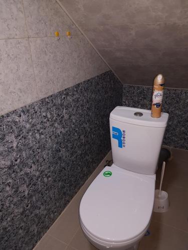 a bathroom with a toilet with a paper on top of it at ECO guest house in Berd