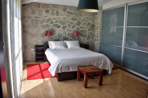 a bedroom with a bed and a red rug at Los Olivos Villa in Sanlúcar de Barrameda