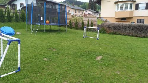 a yard with a batting cage and a goal at Ferienwohnung Graf in Prebl