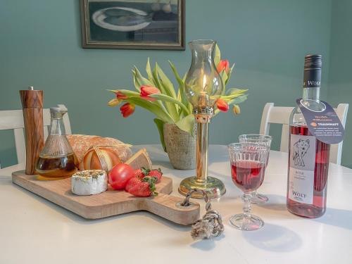 - une table avec une bouteille de vin et un verre dans l'établissement traumHaff denkmalgeschützter Amalienhof Sauna, offener Kamin, Hund, à Gegensee