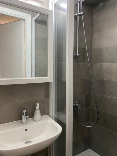 a bathroom with a sink and a shower at Renovated studio in the heart of the Old Town in Menton