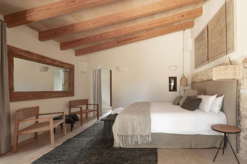 
a bedroom with a bed and a chair at Agroturismo Son Fogueró - Adults Only in Maria de la Salut
