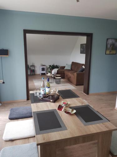 a living room with a wooden table in a room at Vakantieappartement Achat Duitsland in Wirschweiler