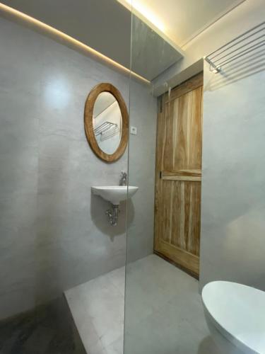 a bathroom with a sink and a mirror at Bukit Tiga Lima Boutique Hotel in Sajang