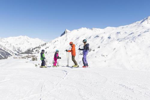 a group of people on skis on a snow covered mountain at Ferienwohnung Stelzis in Wald am Arlberg