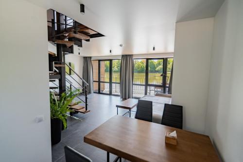 a dining room with a wooden table and chairs at Shepilska Relax Complex in Dovholuka