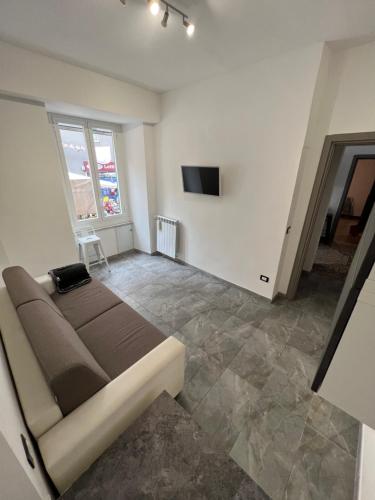 a room with a bed and a television in it at Grey house in Genoa