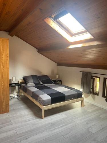a bedroom with a large bed with a skylight at Coucher de soleil en Camargue in Salin-de-Giraud