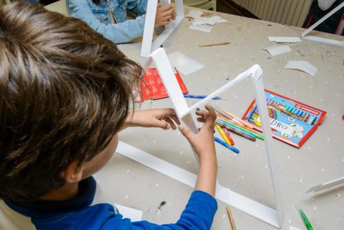 a young boy making a house out of paper at Hotel Nievesol in Formigal