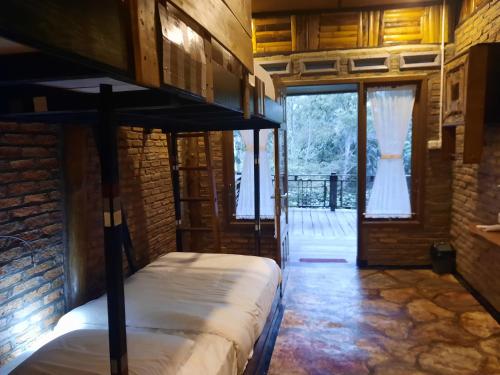 1 dormitorio con litera en una habitación con puerta en The Boat Homestay and Spa, en Balige