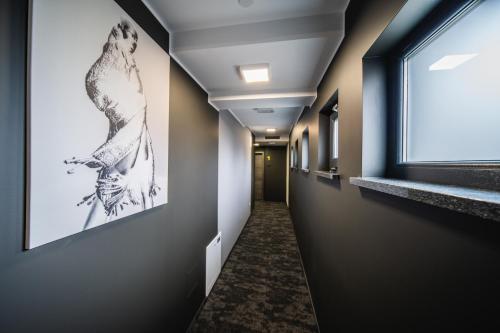 a corridor in a hospital hallway with a window at Rustica Rooms in Čakovec
