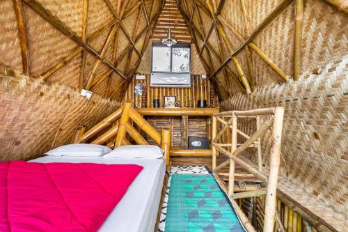 a bedroom in a yurt with a bed and a ladder at Vagatorian - Stylish Luxury Designer Cottages in Vagator
