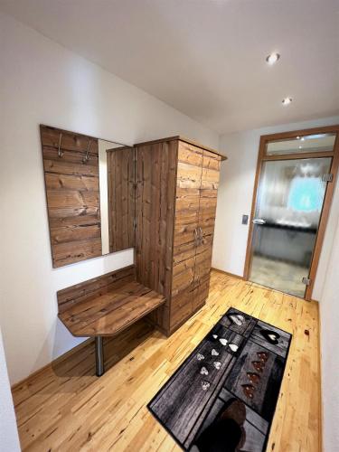 a room with wooden cabinets and a bench in it at Wildkräuter-Gasthof Linde in Löffingen