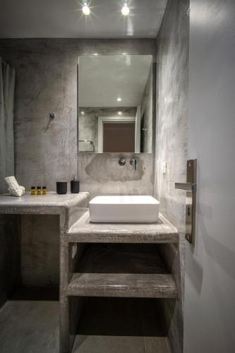 a bathroom with a sink and a mirror at Anius Apartments in Mýkonos City