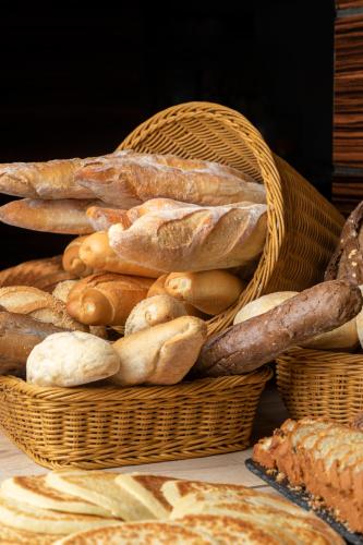 a basket full of bread and pastries on a table at Radisson Hotel Sfax in Sfax