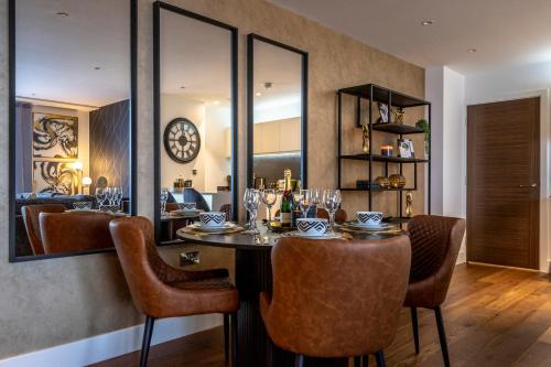 a dining room with a table and chairs and a mirror at Waterside Retreat @ Ryedale House in York