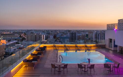 a swimming pool on the roof of a building at Radisson Hotel Sfax in Sfax