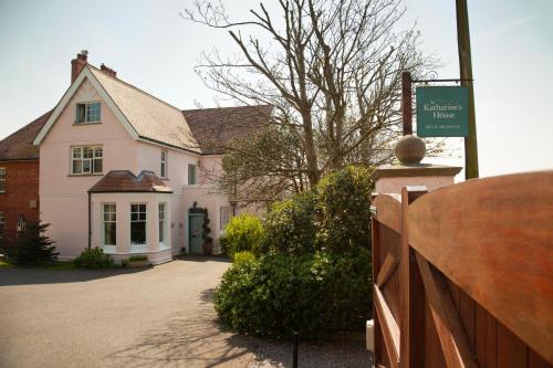 a white house with a fence in front of it at St Katharine's House in Milford Haven