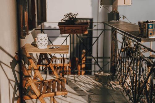 a balcony with a table with a mug on it at Varousi.Traditional house in old town of Trikala 1 in Tríkala