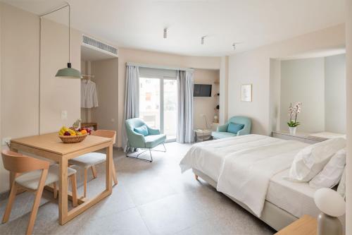 a bedroom with a bed and a table and chairs at Townhouse Lefkada in Lefkada