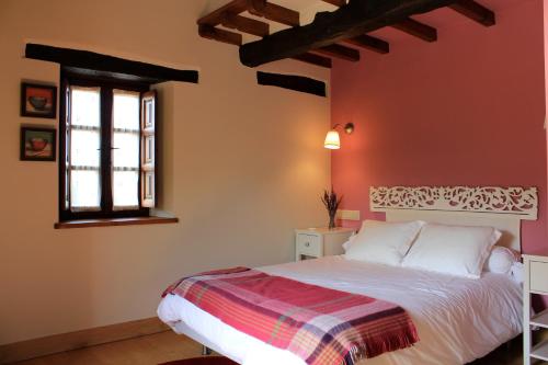 a bedroom with a bed and a window at El Alto de Marín in Hoznayo