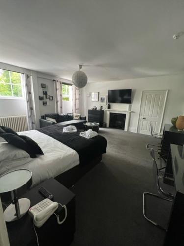 a bedroom with a bed and a living room at Antrobus Hotel in Amesbury