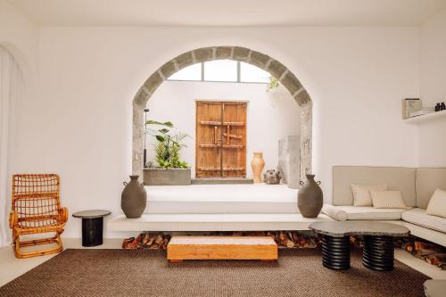 a living room filled with furniture and a window at White Exclusive Suites & Villas in Lagoa