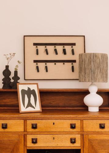a dresser with a lamp and a picture on it at White Exclusive Suites & Villas in Lagoa