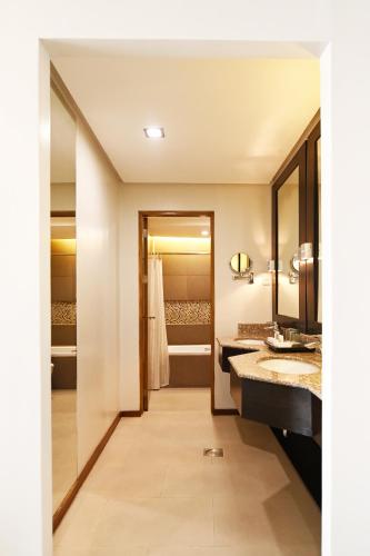 a bathroom with two sinks and a walk in shower at St Mark Hotel in Cebu City
