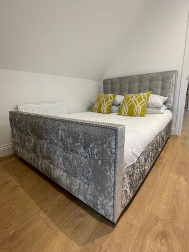 a bed in a room with a metal bed frame at Debussys Guest House in Saffron Walden