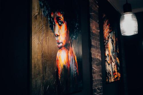 a painting of a woman on a brick wall at Holiday Home in Stepantsminda