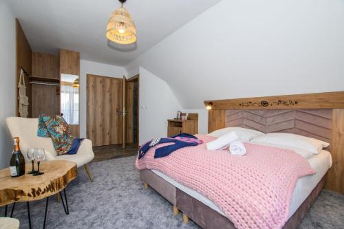 a bedroom with a large bed and a table at Maryna Bór in Zakopane