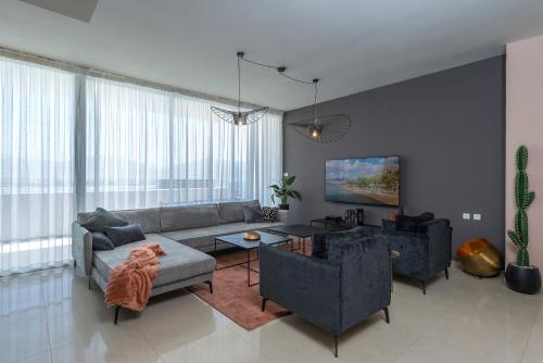 sala de estar con sofá y mesa en Geffen penthouse pool & view, en Eilat