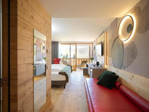 a bedroom with a bed and a living room at RESORT VALFORMICA in Asiago