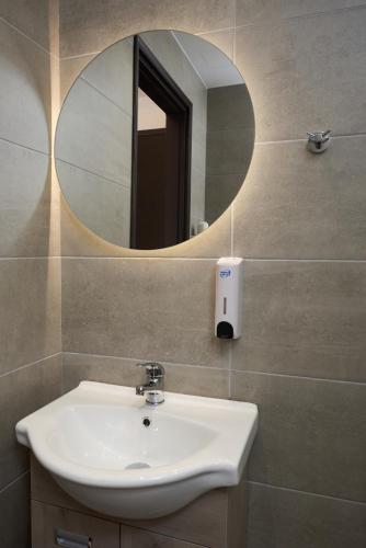 a bathroom with a sink and a mirror at Afroditi Hotel in Plakias