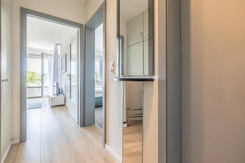 a hallway with a mirror and a door to a room at fewo1846 - Del Mar - komfortable 2-Zimmer-Wohnung mit Balkon im 7 OG in Glücksburg