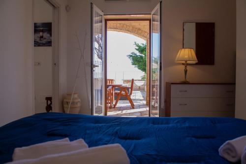 a bedroom with a bed and an open door to a patio at Villa Giada on The Sea in Polignano a Mare