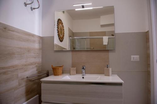 a bathroom with a sink and a mirror at Villa Giada on The Sea in Polignano a Mare
