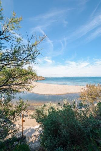 a view of a beach with a cross on it at Les Cabanons de l'Ouille in Collioure