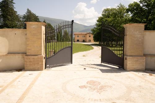 an iron gate with a heart on it in a driveway at Il Castellaccio in Spello