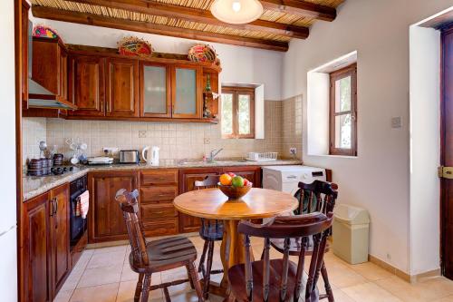 a kitchen with a table with a bowl of fruit on it at Sermar Villa in Episkopi Pafou