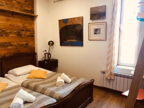 a bedroom with two twin beds and a window at Gallery Guesthouse in Yerevan