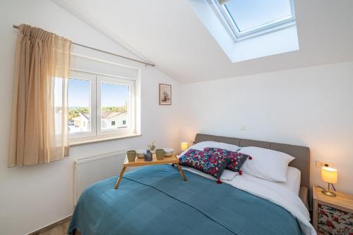 a bedroom with a bed with a table on it at Villa Aurelia in Zadar